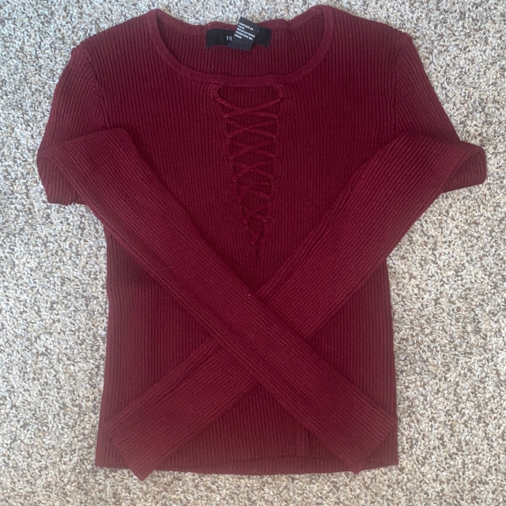 It’s a medium long sleeve crop top there’s lines in the chest.
